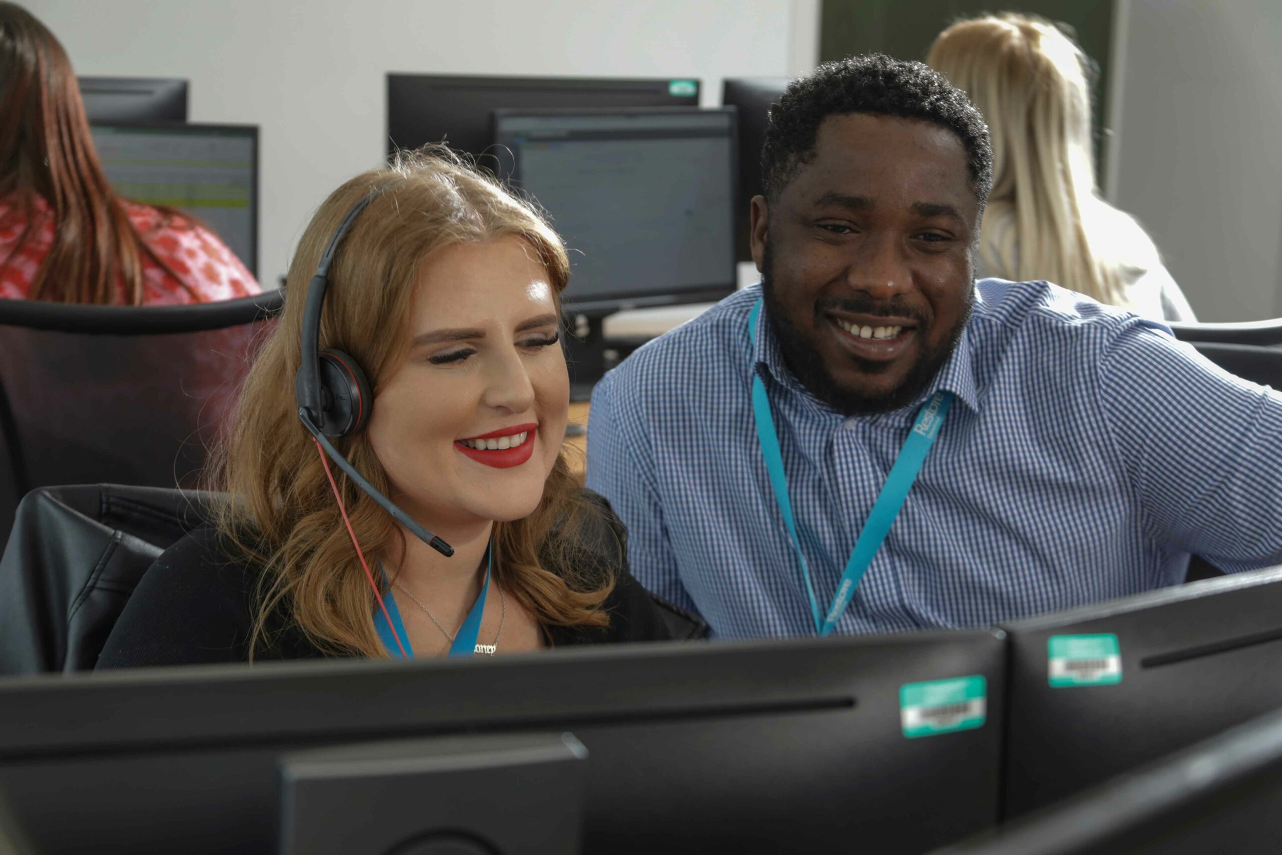 people at a desk smiling