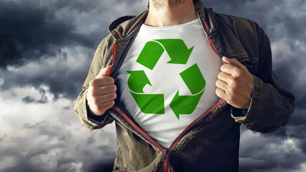 eco shirt with man holding jacket on with sky behind