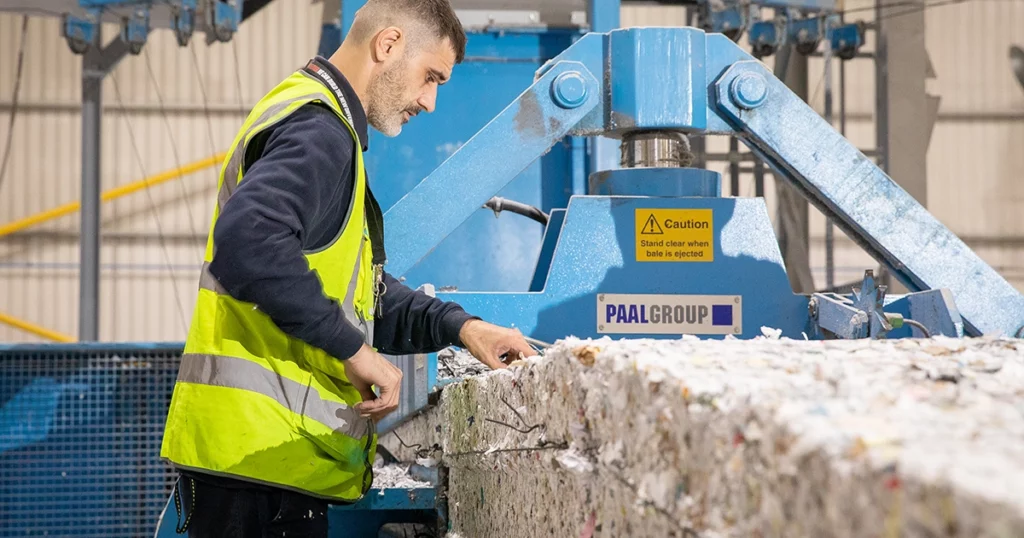 man at paper bale
