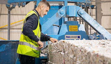 man at a paper bale