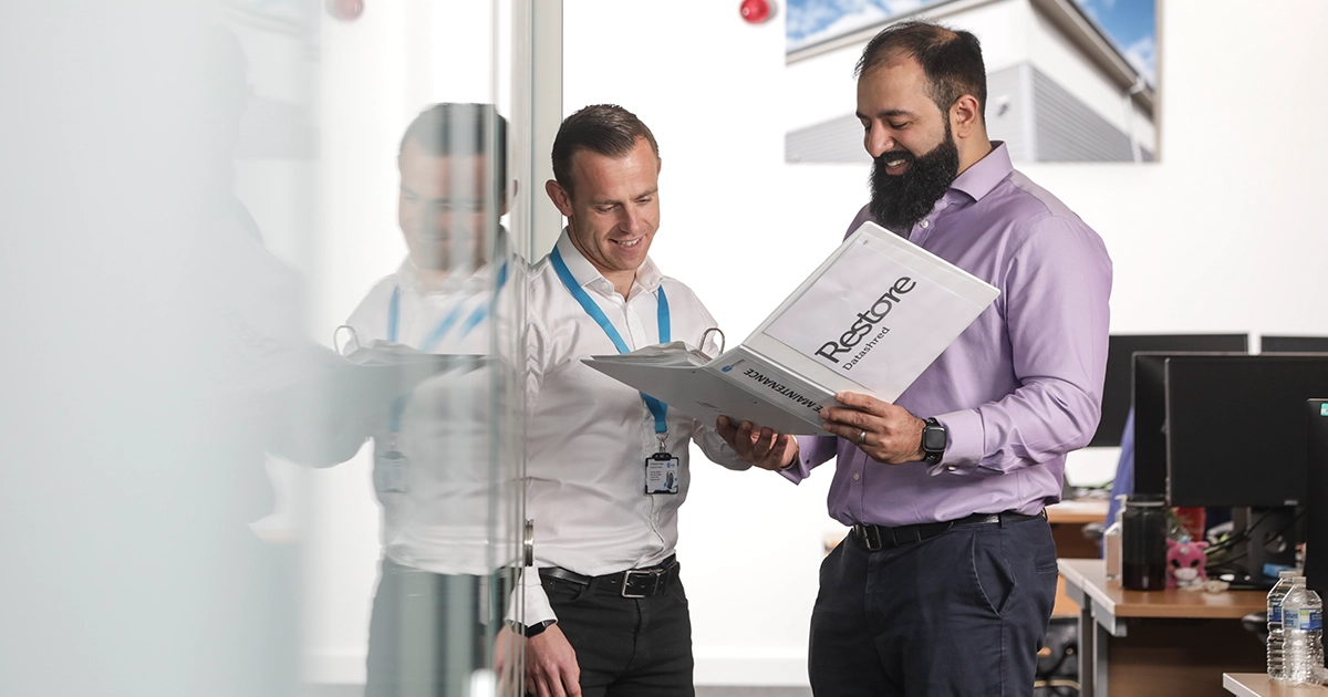 people smiling at a folder