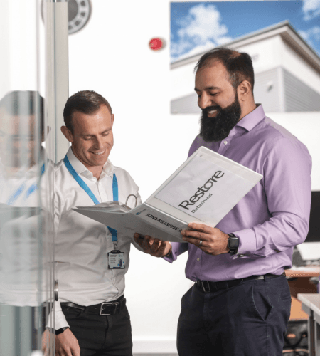 Two staff members discussing frequently asked questions
