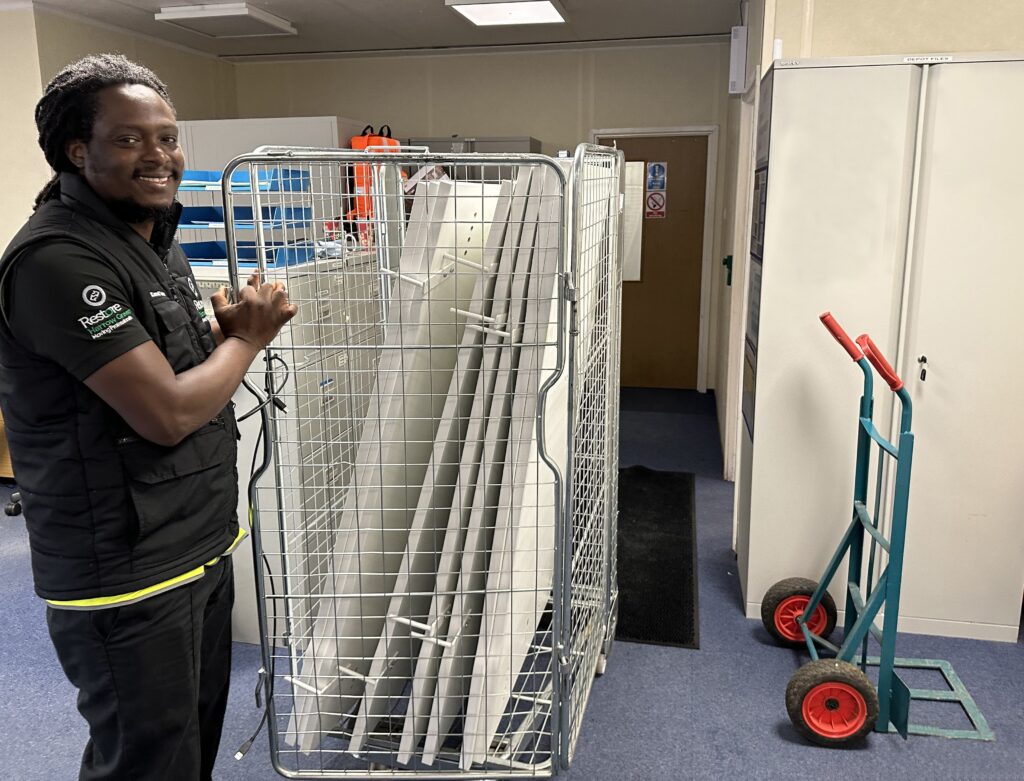 man moving desktops as part of office relocation