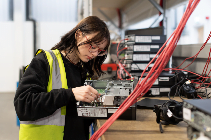 a technology operative dismantling a smart device