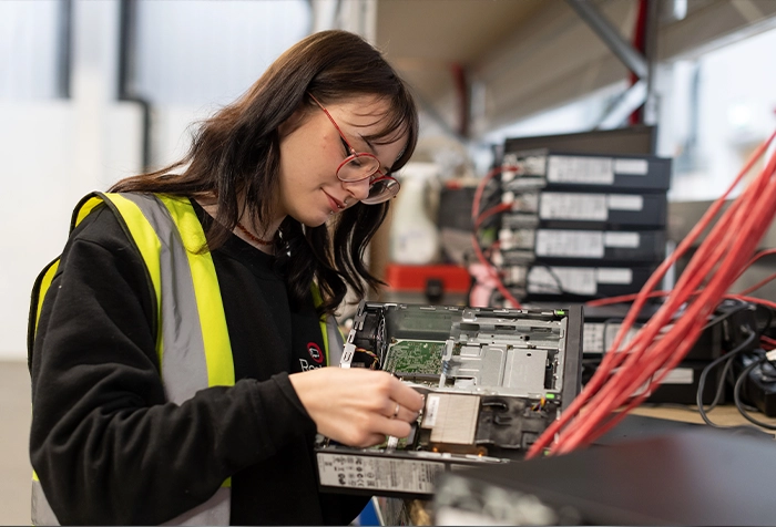 A woman fixing a computer