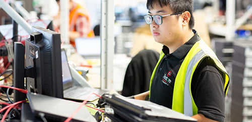 a worker wiring up a PC