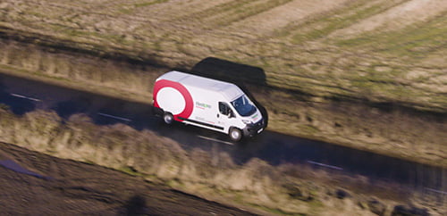 a van driving through a country road